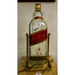 LARGE WHISKEY BOTTLE ON STAND