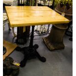 PAIR OF CAST BASE TABLES WITH TIMBER TOPS.