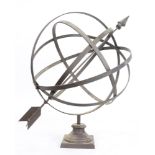 A patinated metal armillary sphere, rising on a square base