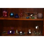 Two shelves of mostly art glass