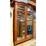 Renaissance Revival walnut armoire with beveled mirrorplate cabinet doors