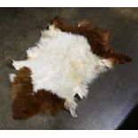 Brown and cream furry animal skin rug