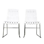 A pair of Modern white side chairs