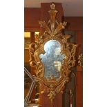 An Italian Rococo style giltwood carved looking glass