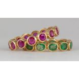 (Lot of 2) Emerald, ruby, 18k yellow gold eternity bands