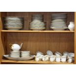 Two shelves of assorted porcelain tableware