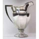 An Art Deco sterling pitcher, the footed octagonal panel form with a helmet spout, 11"h, 24.5 toz