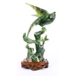 Two carved spinach jade birds on wooden stand, one is phoenix the other possibly a Sparrow