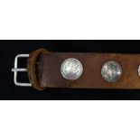A Southwest leather belt mounted with (12) 1881 Morgan silver dollars, 36"l