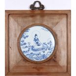 A Chinese wood hanging panel with ceramic inlay, a circular blue and white porcelain screen in the