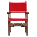 A Spanish Colonial walnut armchair having crimson velvet upholstery with brass nail head trim, the