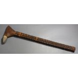 An Austral Islands adze, intricately carved wood with a stone blade held in place by elaborate and