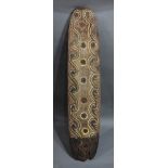 A Papua New Guinea longhouse carved wood panel, having curlicue scroll design around the perimeter