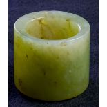 Chinese hardstone archer's ring, of gray celadon hue with dark inclusions, 1"h
