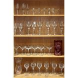 Four shelves comprising of a large Yugoslavian cut glass stemware set cut with flowers (57) together