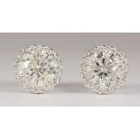 Pair of diamond, 18k white gold earrings Featuring (2) round brilliant-cut diamonds, weighing a