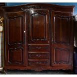 French Provincial Louis XV Style mahogany armoire, the superstructure centering a cabinet door
