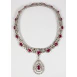 Ruby, diamond, 18k white gold necklace Suspending (1) oval-cut ruby, weighing approximately 3.70