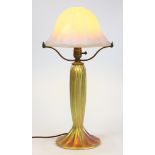 A Lundberg Studios associated table lamp, having a milk glass mushroom shade with iridescent gold
