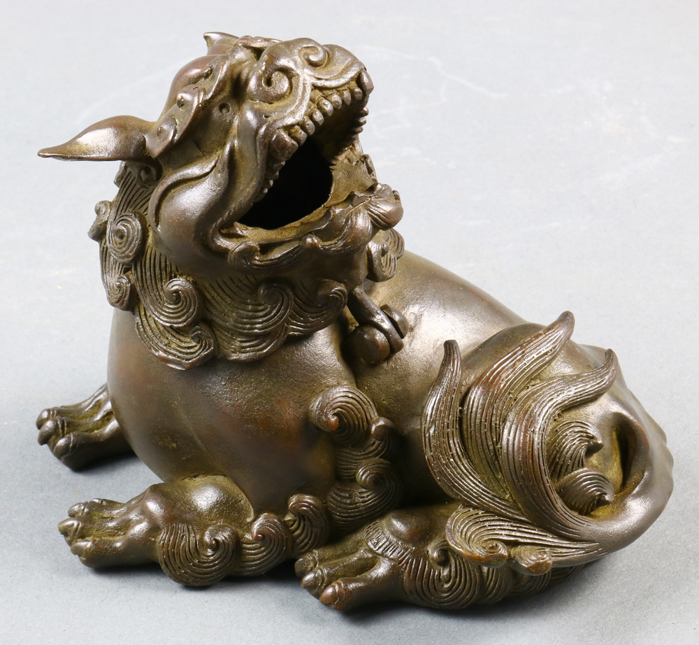 A Chinese Bronze incense burner of recumbent foo lion, size: 4.25"h