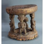 Cameroon carved wood stool with four figures, eroded and old, 12"h x 11" dia.; Provenance: Richard