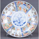 Japanese Imari charger, 19th century, center well in blue-and-white, surrounded by panels with