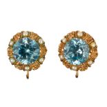 Pair of blue zircon, seed pearl, 14k yellow gold earrings Featuring (2) round-cut blue zircons,