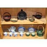 (lot of 19) two shelves of Japanese items: iron ware, consisting of one handled pot, one sake server