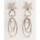 Pair of diamond, 14k white gold star earrings Featuring (60) full-cut diamonds, weighing a total