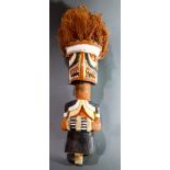 Wild Malanggan, New Ireland figure with brown and orange raffia hair, hands joined at waist, 20"h
