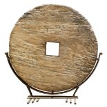 Large wooden cart wheel, sign of age and use, with Modernist custom base, possibly Indonesian,