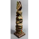 A Pacific Northwest Coast Kwakiutl cedar painted totem pole, early 20th Century, depicting a