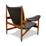 A Finn Juhl for Baker Chieftain chair, circa 1998, executed in black leather, the tufted shaped