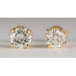 Diamond, 14k yellow gold stud earrings Featuring (2) full-cut diamonds, weighing a total of