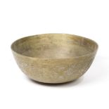 An Asian-style Brass bowl, incised with floral and foliage scrolls, a dragon shaped mark to the