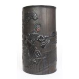 A Chinese carved wood brush pot, of cylindrical shape and carved with theater figures dancing in the