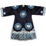 A Chinese blue silk embroidered robe, embroidered with crane roundels, the major roundels are