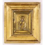 A Russian gilt brass oklad icon of the Mother Mary in Deisus, holding a cross, the face and hands