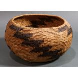 A Pomo Native American Indian single rod coiled basket, Northern California, having a slightly