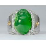 Jadeite, diamond, 18k gold ring Featuring (1) carved jadeite fu dog, accompanied by a Gemological