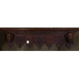 An Edwardian carved wood wall rack, with angel head supports, 11"h