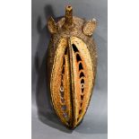 A Papua New Guinea, Abelam Yam Mask, having an elongated face with fine, brown, gold, and red