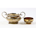 (lot of 2) A Victorian sterling bowl lot: the first, a gilt wash waste bowl decorated with floral
