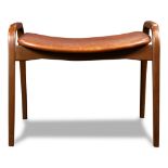 A Swedish Modern bench, having a brown leather seat/cushion, above tapered legs, 18.5"h