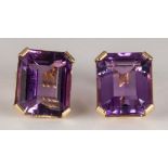 Pair of amethyst, 14k yellow gold earrings Featuring (2) emerald-cut amethysts, weighing a total