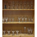 Three shelves of cut glass stemware comprising a matched set of 29 wine and champagne coupes