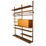 Modern teak and chrome wall shelving unit, consisting of (9) shelves and a fall front cabinet,