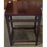 Contemporary side table, having a mahogany finish and rising on tapered legs conjoined by the box