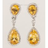 Pair of citrine, diamond, 18k white gold earrings Featuring (4) pear-cut citrines, weighing a