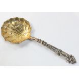 A French gilt vermiel silver serving spoon, the gilt radiating scalloped shell bowl cast with a